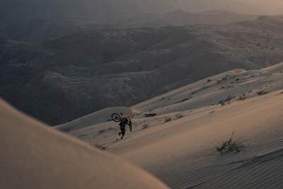 Kilian Bron et son vélo sur le Cerro Blanco, une dune de sable culminant à 2000 mètres au Pérou.