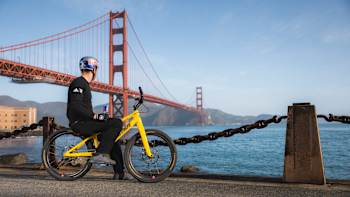 Danny MacAskill on his bike looking out towards Golden Gate Bridge, San Francisco, USA.