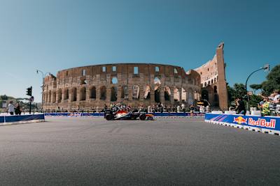 A F1 car in front of the Colosseum in Rome, Italy.