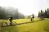 A MTB rider does a wheelie on singletrack in Carinthia, Austria.