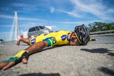 Cyclist kisses the ground at the end of Grand Tour stage