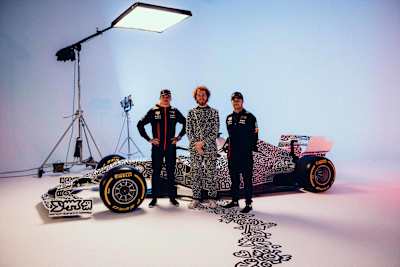 Max Verstappen, Mr Doodle and Sergio Pérez pose in front of the RB14 racecar during a photo shoot of the collaboration between Oracle Red Bull Racing and Mr Doodle in London, United Kingdom in 2023.