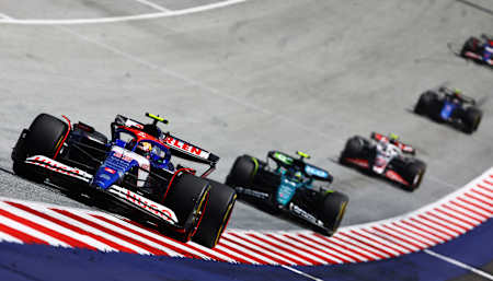 Yuki Tsunoda leads Fernando Alonso during the Sprint ahead of the F1 Grand Prix of Austria at Red Bull Ring on June 29, 2024 in Spielberg, Austria. 