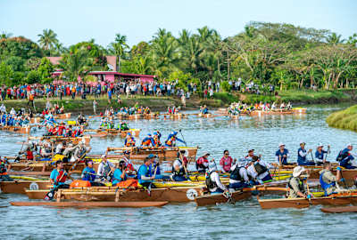 The race's start is pure bedlam as 66 teams scramble into outrigger canoes and fight rush-hour traffic as they head toward the sea.