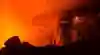 A glow of the climber's head lamp can be seen next to the lava lake