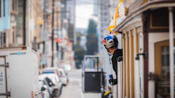 Danny MacAskill leans out a tram in San Francisco.