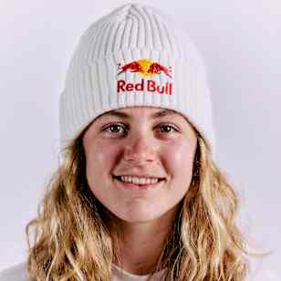 Cyclist Zoe Bäckstedt is pictured wearing a Red Bull branded white beanie, capturing the brand's dynamic energy in a stylish portrait (UK 2024)