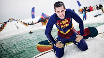 A competitor crawls out of the water at Red Bull Jump and Freeze 2013 in Gudauri, Georgia