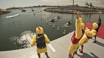 The Chicken Whisperers celebrate as they watch their pilot setting a new Red Bull Flugtag world record distance.