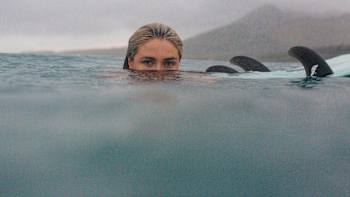 Ivy Miller poses for a portrait image with just her head above water.