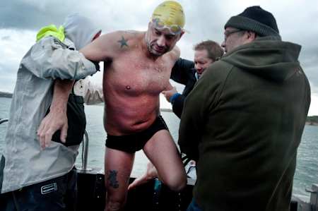 Howard James is helped aboard after finishing