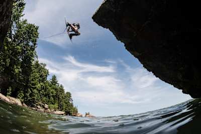 With the use of a high powered winch, Mike Dowdy wakeboards on natural features along the shores of Lake Superior in northern Wisconsin, USA on July 10, 2017.