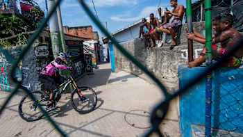 Filip Polc rides his DH mountain bike through the narrow streets of a favela in Rio de Janeiro.