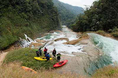 The group of kayakers scouting a rapid at the Santo Domingo river during the steepest kayakable river descent