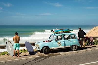 A perfect wave breaks in front of a road in Morocco.