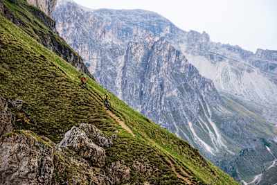 A pair of mountain bikers tackle a steep trail in the Dolomites
