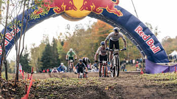 In 2023, Vlad Dascălu races through the Red Bull arch at the UCI XCO World Cup event in Mont-Sainte-Anne, Canada.