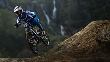 Ronan Dunne riding in front of the Hardline waterfall at Red Bull Hardline 2024 Dinas Mawddwy, United Kingdom on May 31, 2024