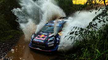Grégoire Munster of M-Sport Ford World Rally Team surges through water at the World Rally Championship Paraguay in Encarnacion, Paraguay, on August 30, 2025, with bold Red Bull branding