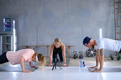 Athletes are doing push-ups during a strength training session.