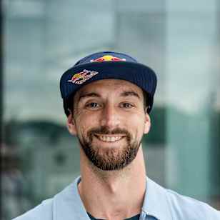 In 2025, Mike Brewer is seen posing in Fuschl am See, Austria, wearing a Red Bull cap and branded jacket during an energetic Red Bull photo shoot