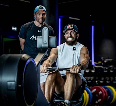 Alexander Rončević seen on a rowing machine during training for HYROX competition.