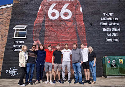 An image of footballer Trent Alexander Arnold in front of his mural.