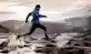 Runner splashes over marshy ground out in the mountains.
