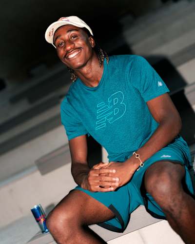Yan Diomandé smiles during a portrait photoshoot in Saalfelden, Austria, on 5 August 2026, wearing a teal New Balance shirt beside a Red Bull can