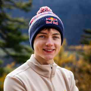 In November 2025, Toby Roberts sports Red Bull gear amidst the stunning autumn scenery of Ticino, Switzerland, embodying the adventurous Red Bull spirit.