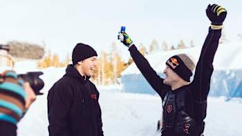 Daniel Bodin celebrates landing his snowmobile double backflip