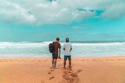 Andy Burgess and Hugo Pinheiro survey the surf at Pipeline on the North Shore of Hawaii.