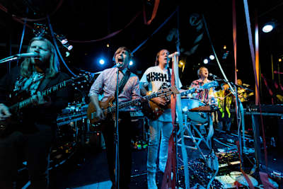 An image of Arcade Fire performing live at KROQ Studios for Red Bull Sound Space on 31 July 2014.