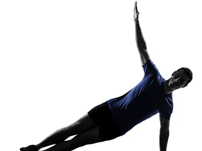 Man performs side plank exercise 