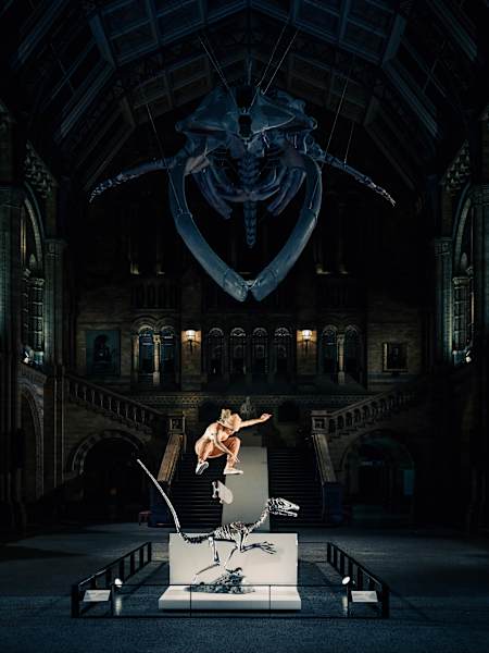 Brazilian skater Leticia Bufoni kickflipping over a velociraptor dinosaur skeleton in the main hall at London's Natural History Museum, April 2023.