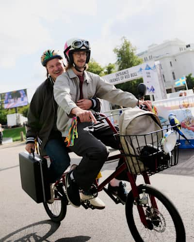 In 2024, two smiling participants race on a tandem bicycle at the Red Bull Stalen Ros event in Gothenburg, Sweden