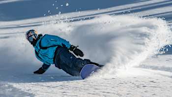 A snowboarder competes at the Natural Selection Tour Revelstoke 2022.