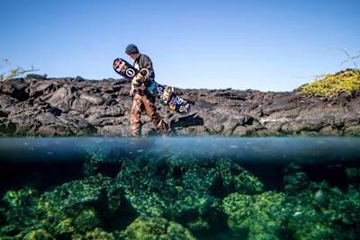 Snowboarder Lyon Farrell walking at a lake in Hawaii