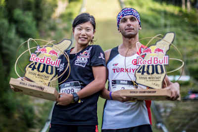 Yukari Tanaka of Japan and Ahmet Arslan of Turkey celebrate with their winners trophies after the Red Bull 400 World Championship at Titisee-Neustadt, Germany on July 15th 2017.