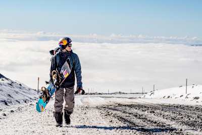 Snowboarder Lyon Farrell hiking at Mauna Kea