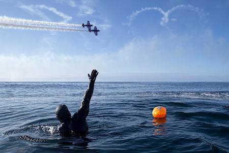 Ross Edgley waves to the Red Bull Matadors air display team during his Great British Swim attempt.