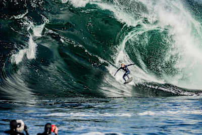Surfer Mick Fanning rides a giant wave at Shipstern Bluff in Tasmania