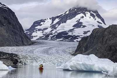 Two adventurers canoeing infront of the Jacobsen glacier.