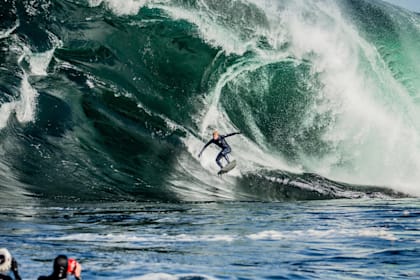 Surfer Mick Fanning rides a giant wave at Shipstern Bluff in Tasmania