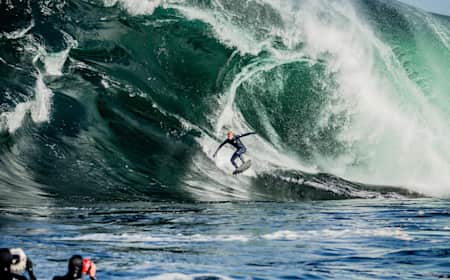 Surfer Mick Fanning rides a giant wave at Shipstern Bluff in Tasmania