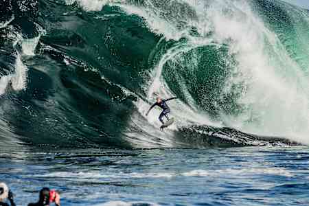Surfer Mick Fanning rides a giant wave at Shipstern Bluff in Tasmania