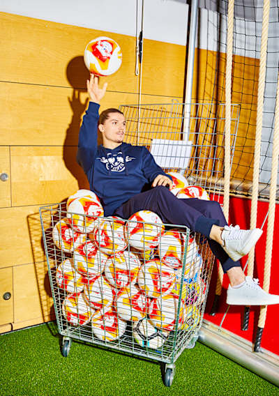 Marcel Sabziter balances a football during a photoshoot for The Red Bulletin.