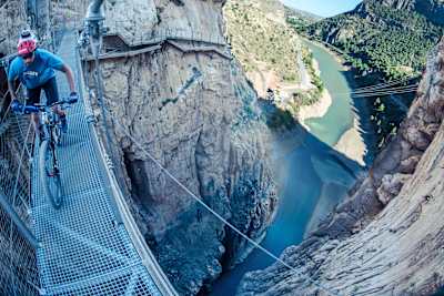 David Cachon crosses a bridge on his MTB on the El Caminito del Rey gorge walkway near Malaga, Spain