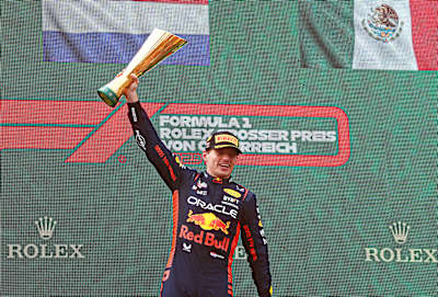 Race winner Max Verstappen celebrates on the podium during the F1 Grand Prix of Austria at Red Bull Ring in 2023.