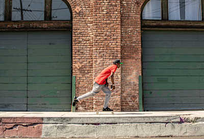Kareem Campbell pushes his skateboard along a sidewalk in LA.
